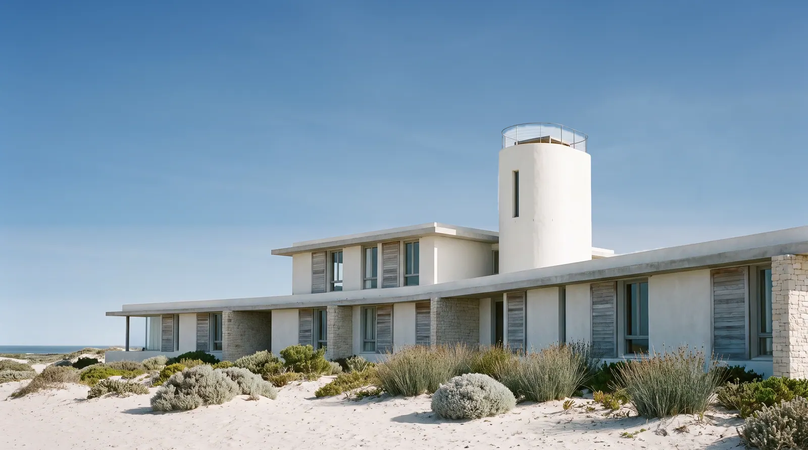 Newel: a long, low hotel of lime plaster and limestone on the dunes, with a slim round tower